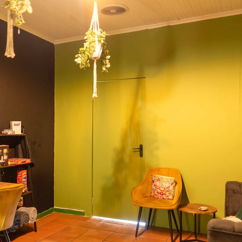 Olive walls and a mustard velvet chair